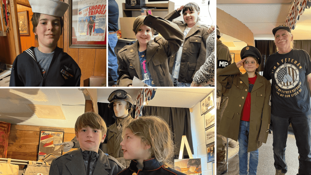 Kids trying on military uniforms at the Veterans History Museum in Downtown Brevard, NC